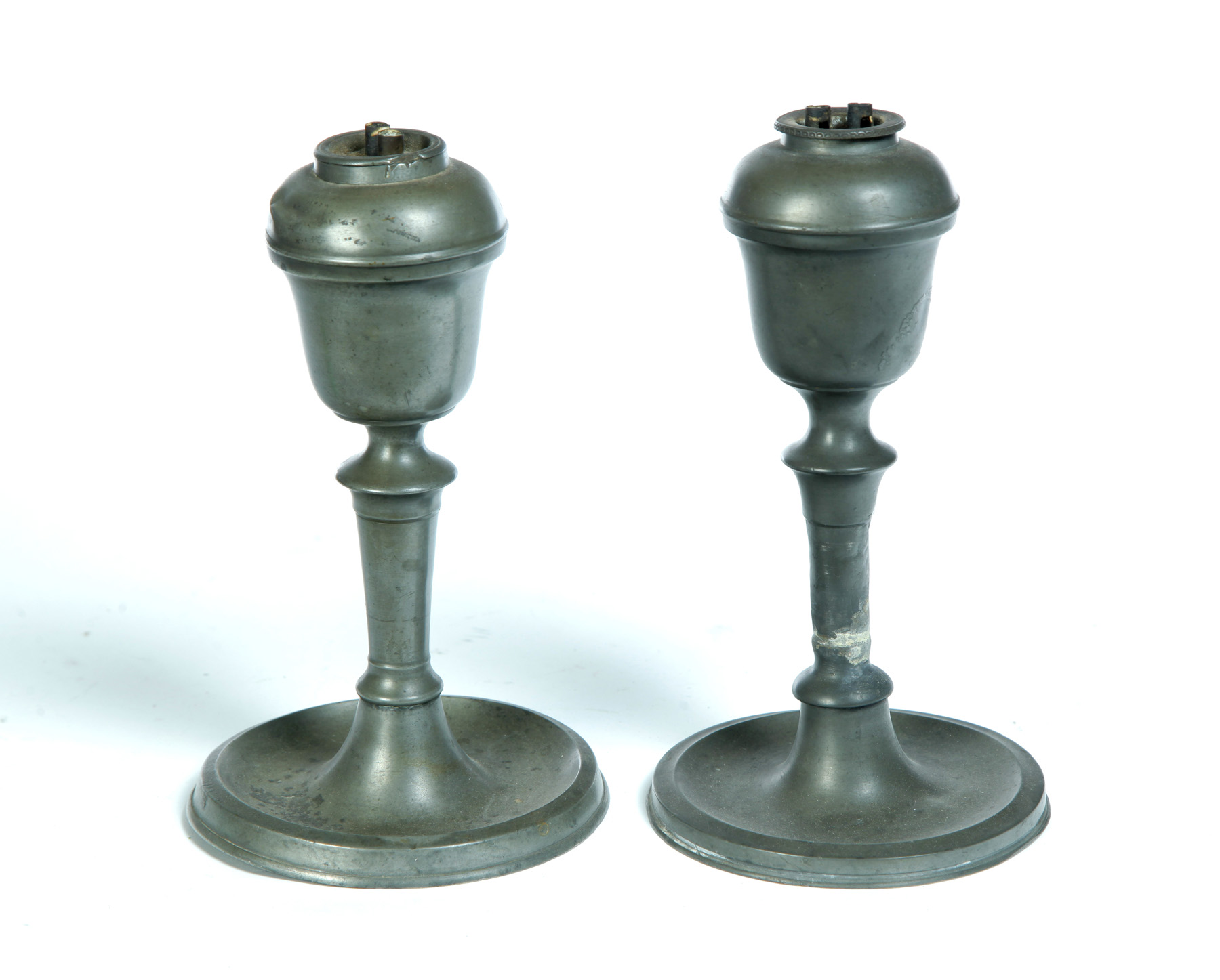 Appraisal: PAIR OF HOMAN PEWTER OIL LAMPS Cincinnati Ohio mid th