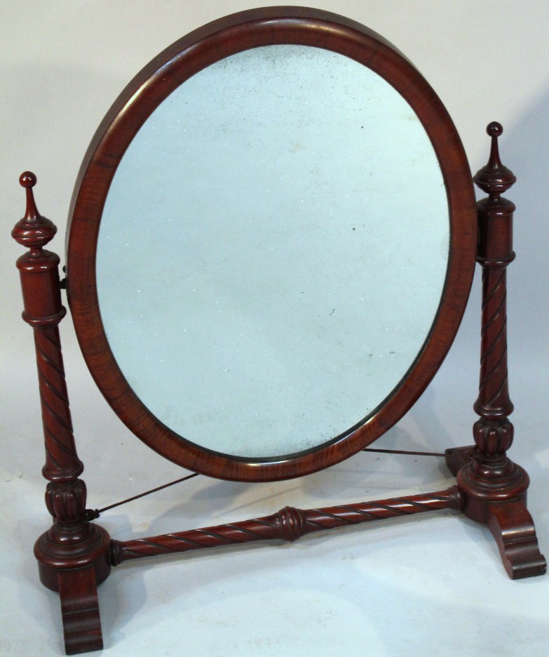 Appraisal: A Victorian mahogany table mirror the oval glass flanked by