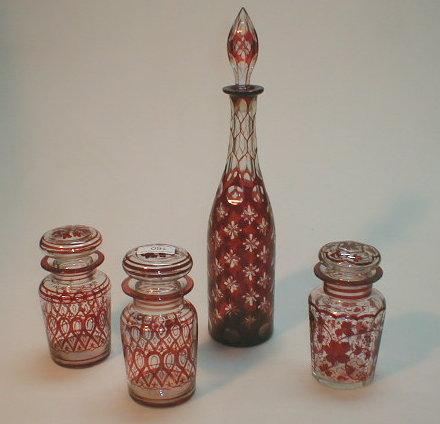 Appraisal: Flashed ruby glass decanter and three pickle jars