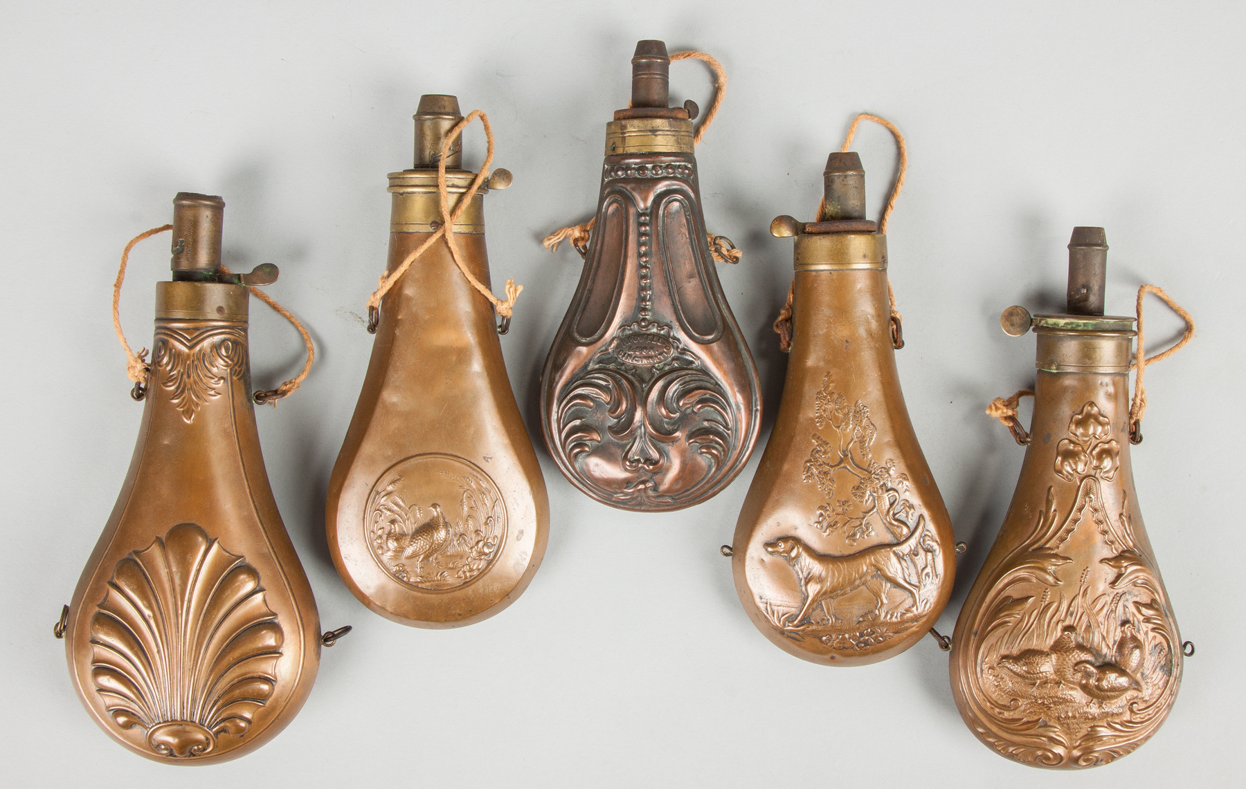 Appraisal: Group of Brass Embossed Powder Flasks th century One marked