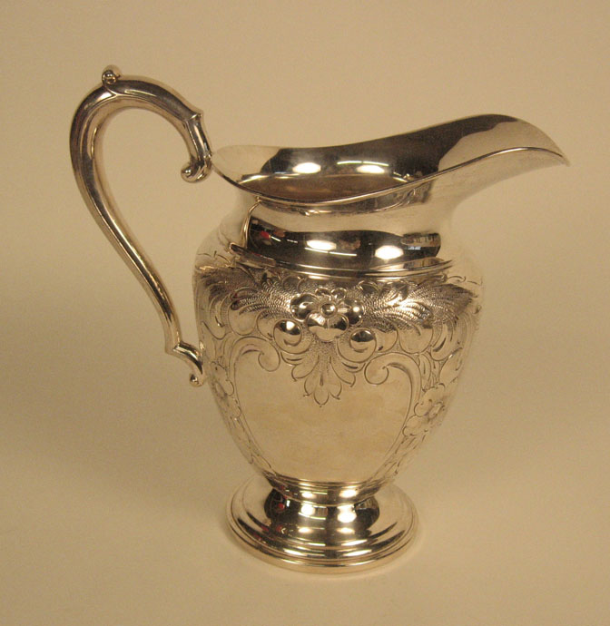 Appraisal: Whiting sterling silver repousse water pitcher Decorated with flower heads