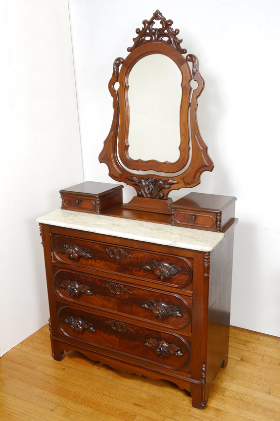 Appraisal: CARVED VICTORIAN VANITY CHEST OF DRAWERS Articulated top mirror with