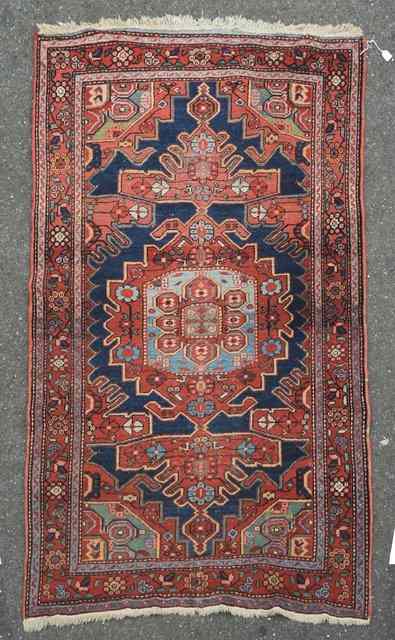 Appraisal: AN ANTIQUE PERSIAN KASHGAI RUST GROUND RUG decorated with a