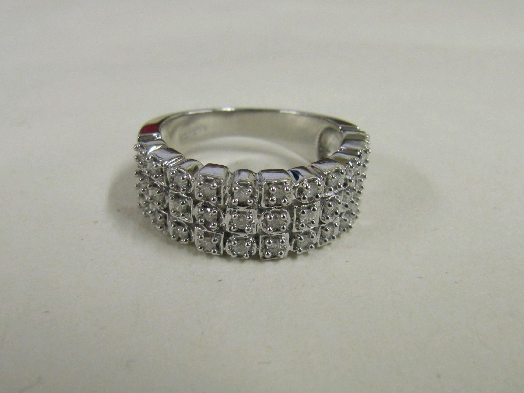 Appraisal: Nine carat white gold triple row diamond set band