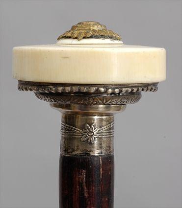 Appraisal: STAINED WALNUT WALKING STICK WITH SILVER-MOUNTED IVORY HANDLE The disc