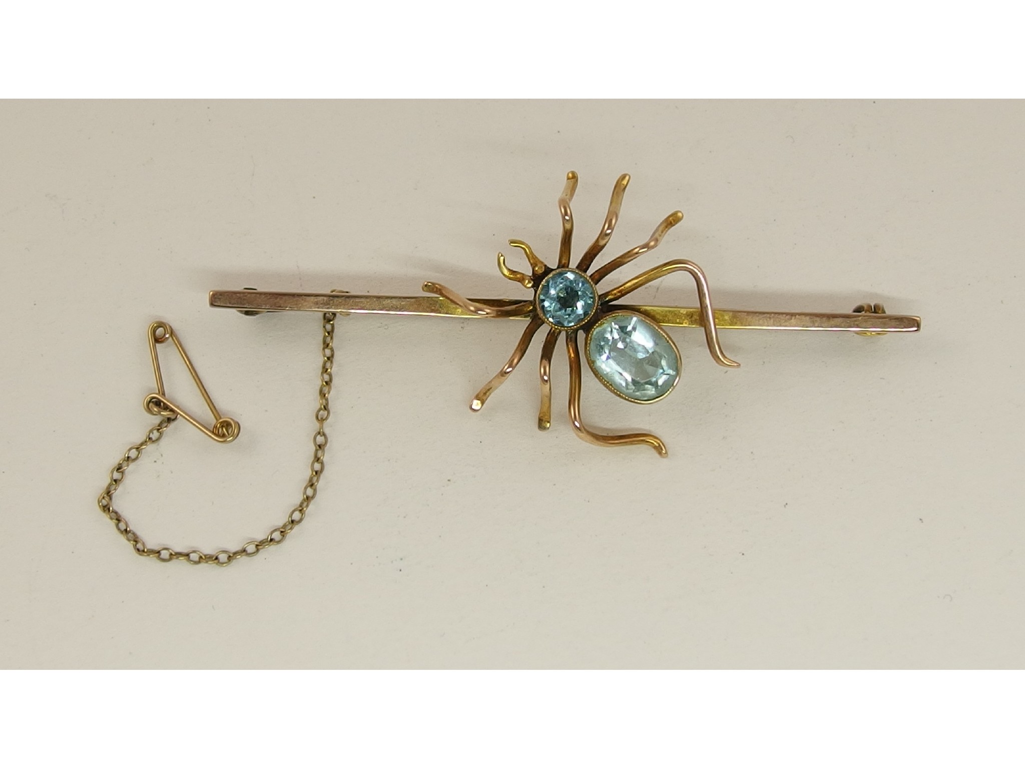 Appraisal: A ct spider bar brooch set with pale blue gem