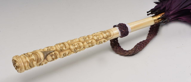 Appraisal: A Japanese parasolcirca with ivory handle carved with Noh masks