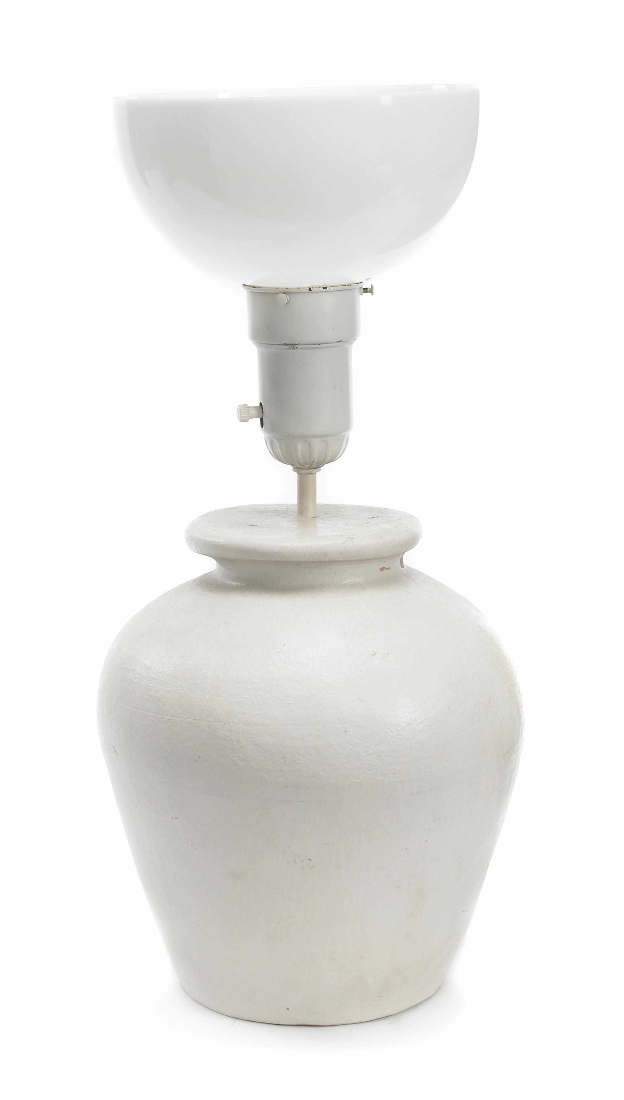 Appraisal: A Solon Larkin plaster decorated terracotta lamp Incised on underside