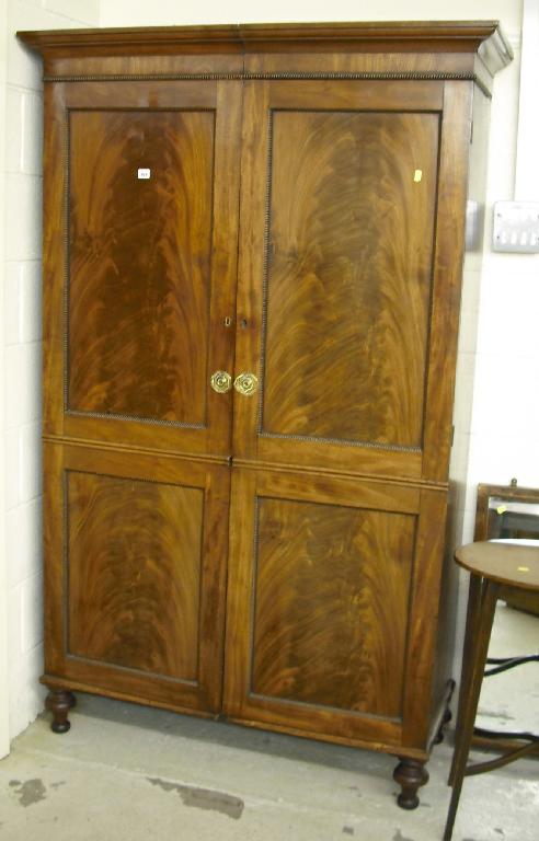 Appraisal: th century flamed mahogany wardrobe with moulded cornice over two