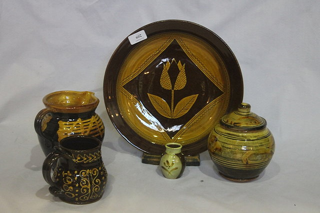 Appraisal: A WINCHCOMBE POTTERY SLIPWARE JAR and cover and four other