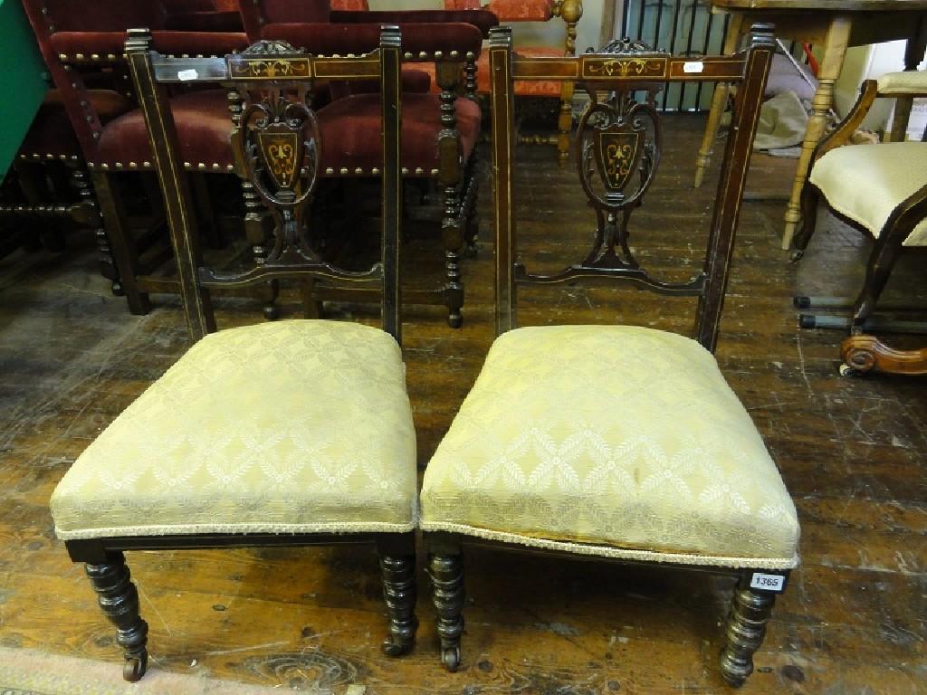 Appraisal: A pair of inlaid Edwardian mahogany occasional chairs with pierced