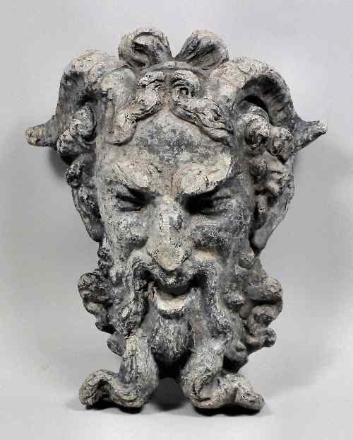 Appraisal: A cast lead mask of a satyr with gaping mouth