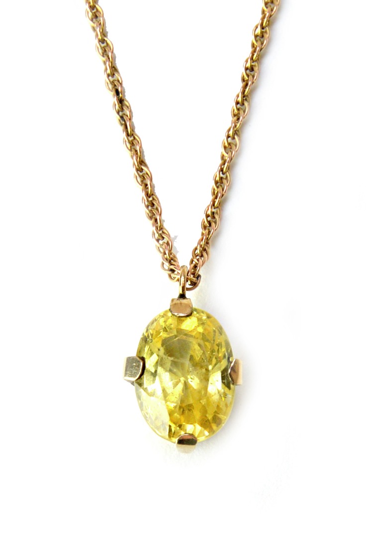 Appraisal: A yellow sapphire set single stone pendant claw set with