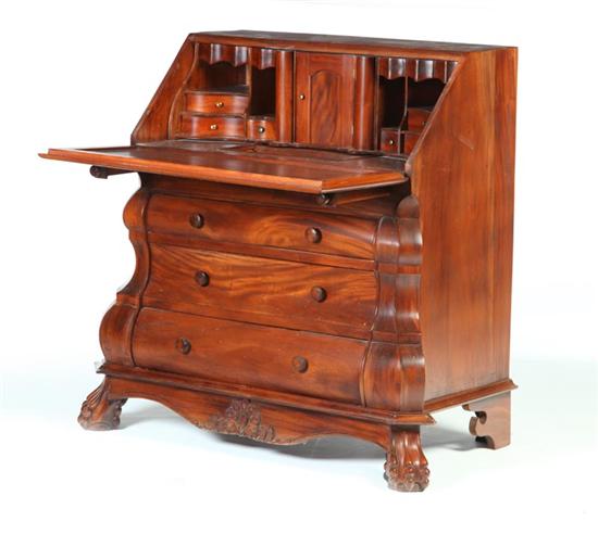 Appraisal: BOMBE EUROPEAN-STYLE DESK American th century mahogany Shaped facade with