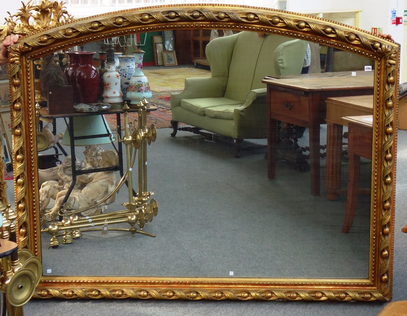 Appraisal: A large th century gilt framed arched top wall mirror