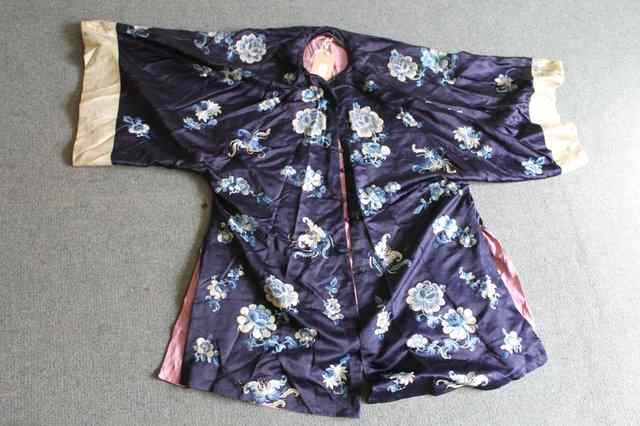 Appraisal: A CHINESE DARK BLUE SILK ROBE with lilac silk lining