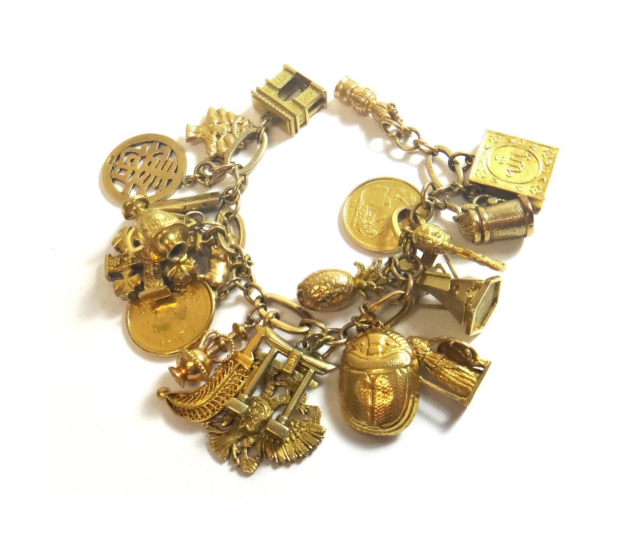 Appraisal: A gold oval and circular link charm bracelet fitted with