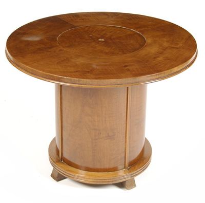 Appraisal: An Art Deco veneered drum table with sprung loaded cocktail