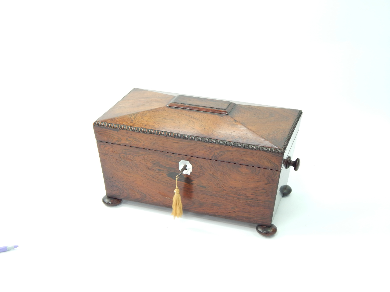 Appraisal: A Regency rosewood tea caddy of sarcophagus form the lid