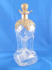 Appraisal: A late Victorian silver mounted decanter the unusual body rising