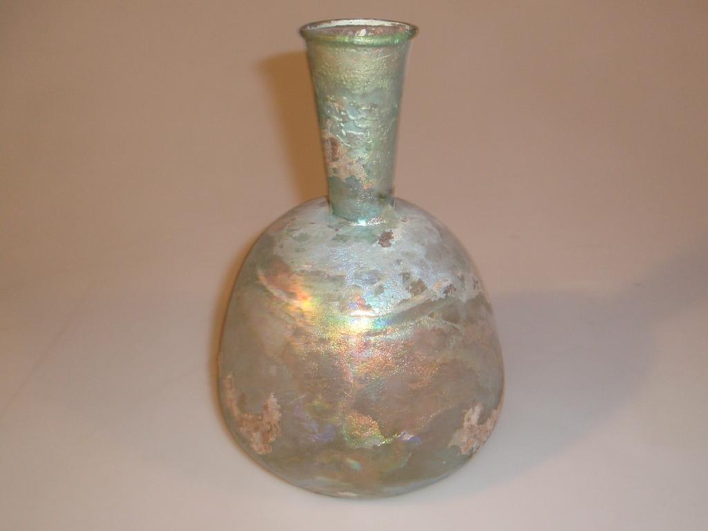 Appraisal: A large Roman bluish-green glass bottle the wide funnel neck