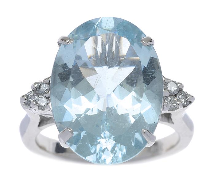 Appraisal: AN AQUAMARINE AND DIAMOND RING The oval cut aquamarine weighing