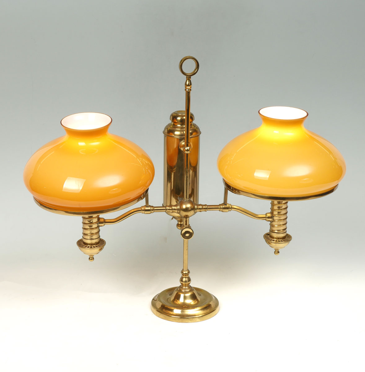 Appraisal: BRASS TWO LIGHT STUDENT LAMP Cased glass shades Removable shade