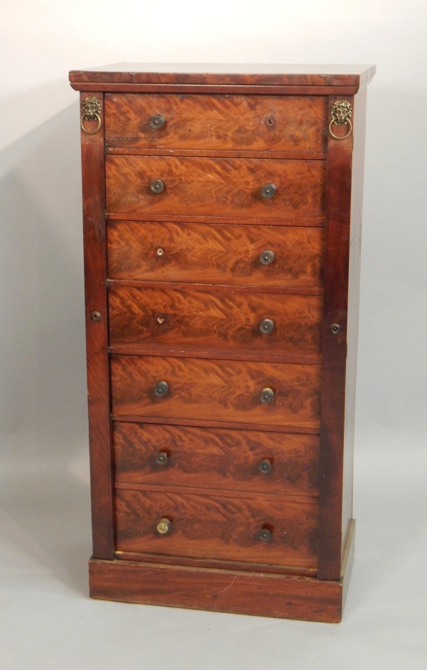 Appraisal: A George IV figured mahogany Wellington chest with an arrangement