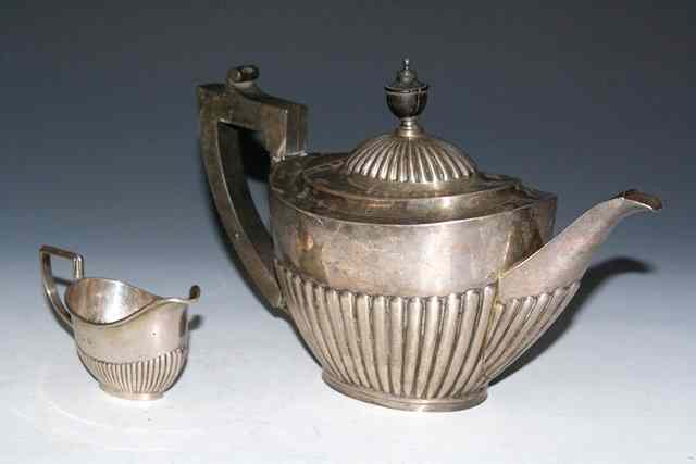 Appraisal: A LATE VICTORIAN SILVER OVAL TEAPOT with a fluted lower