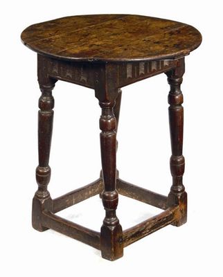 Appraisal: An oak joined table the circular boarded top above a