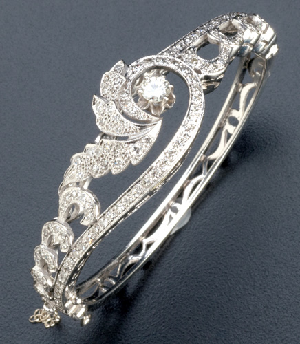 Appraisal: Diamond k wg hinged bangle of asymmetric scroll and leaf