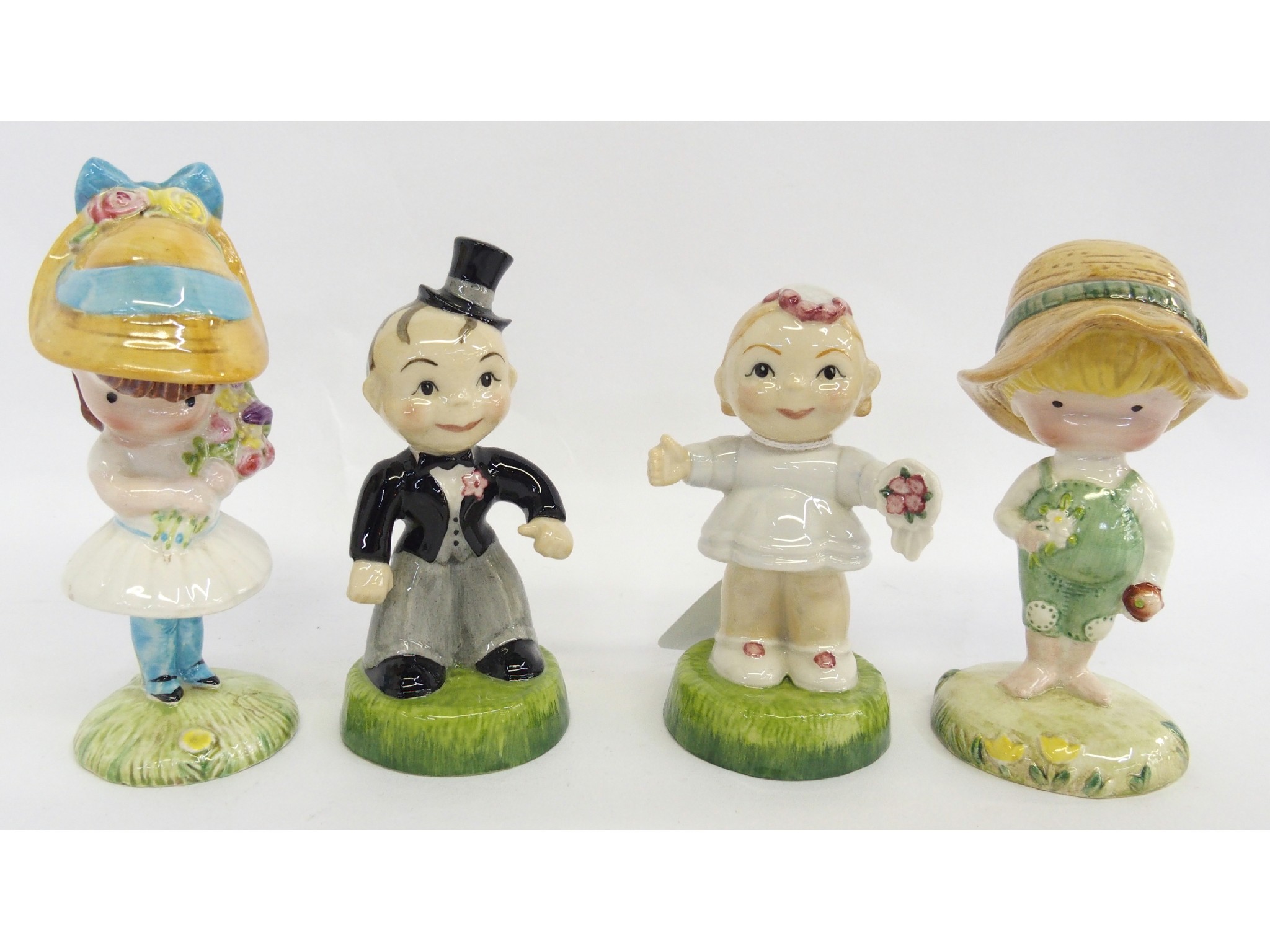 Appraisal: Two Carlton Kids figures including Bride and Groom and two