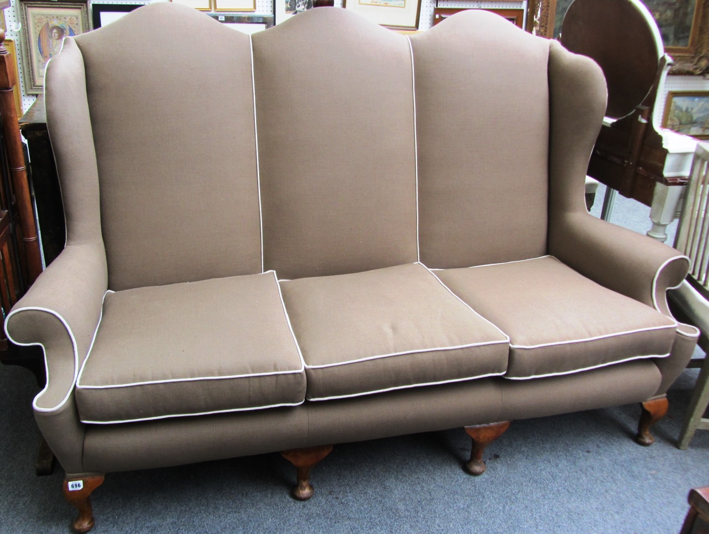 Appraisal: A Queen Anne style triple hump high back sofa on