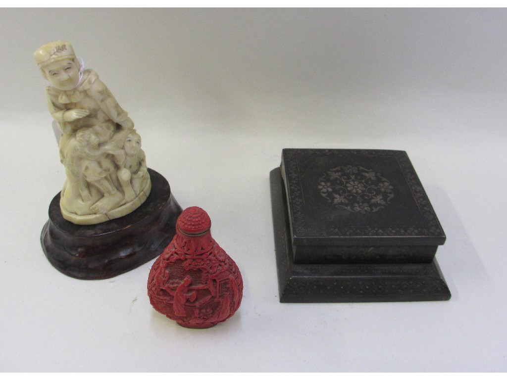 Appraisal: Carved ivory figure cinnabar snuff bottle and a cigarette dispenser