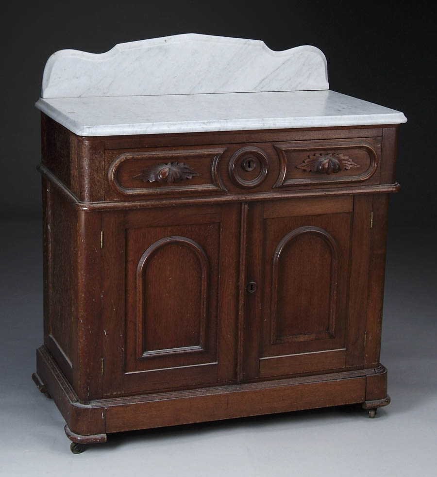 Appraisal: MARBLE TOP VICTORIAN WALNUT COMMODE White molded edge marble has