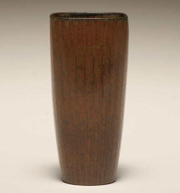 Appraisal: A ribbed vase in a brown glaze designed by Gunnar