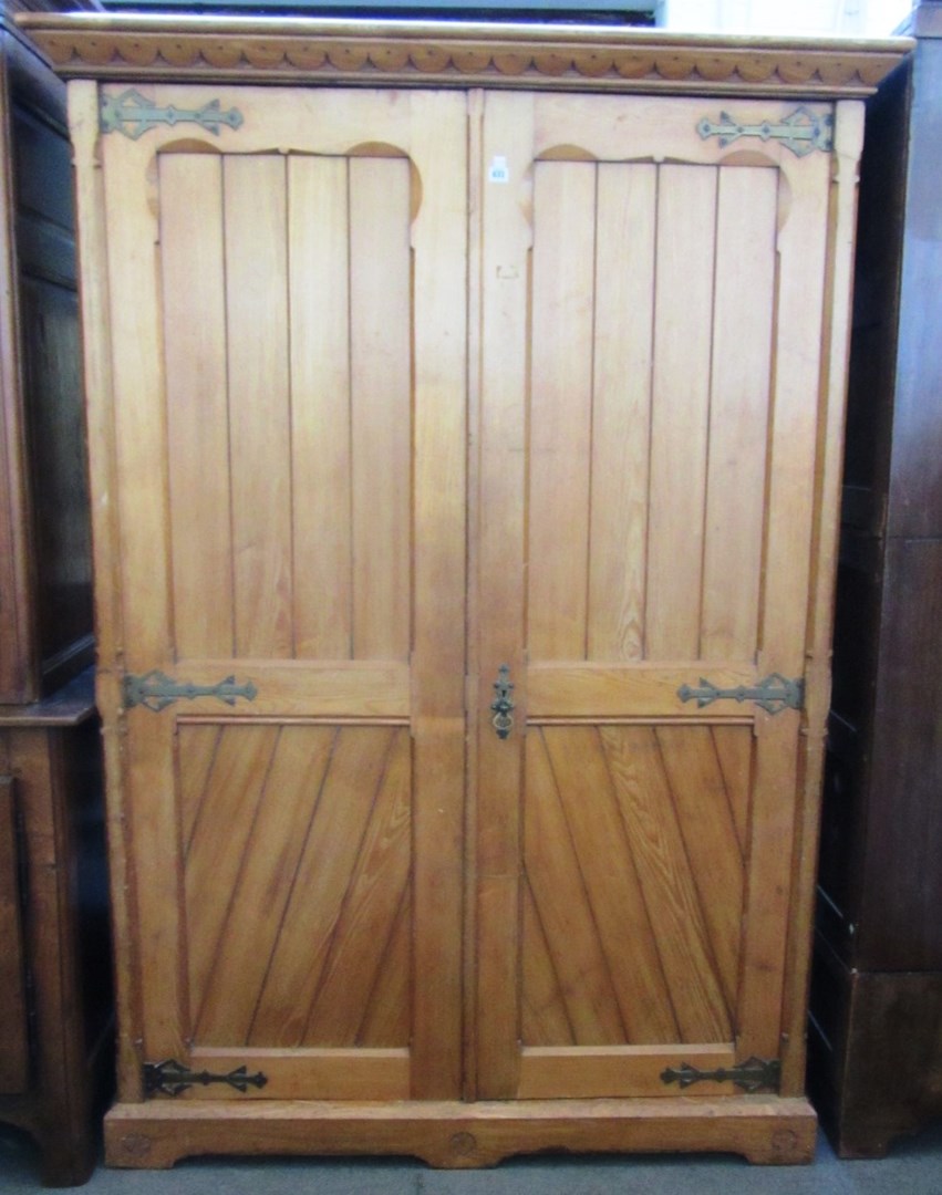 Appraisal: A Victorian ash wardrobe the doors with Gothic brass strapwork