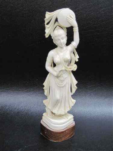 Appraisal: IVORY CARVED FIGURE SCANTILY CLAD FEMALE DANCER holding tambourine over