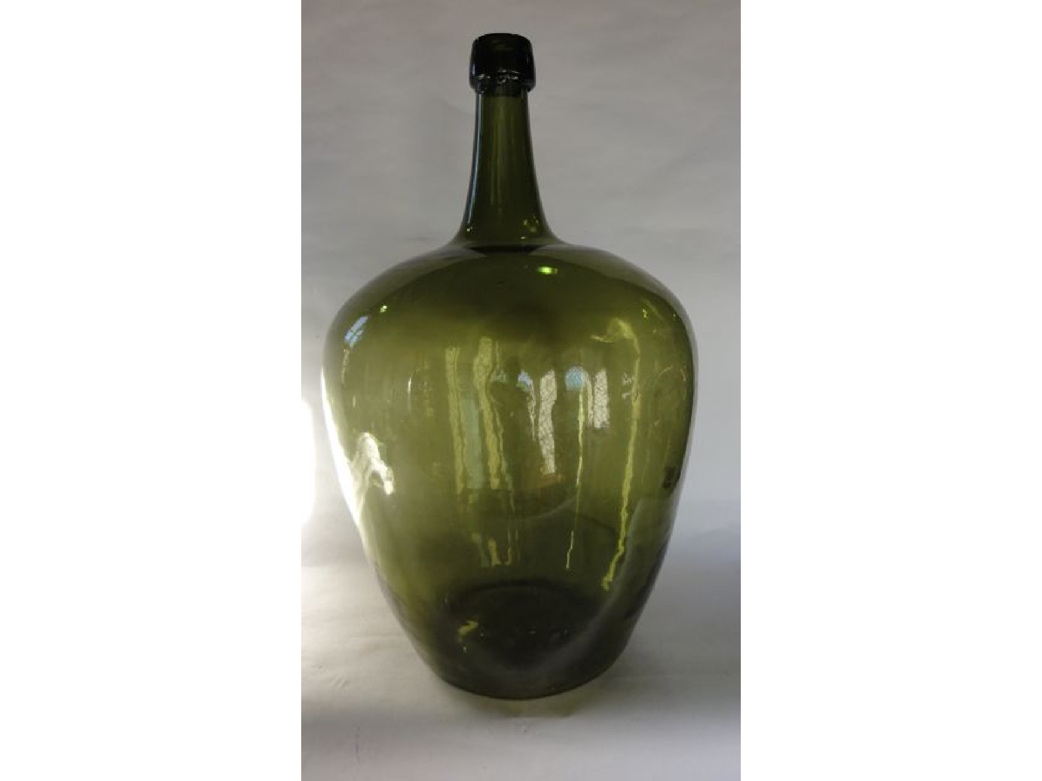 Appraisal: A substantial green glass bottle of baluster form with drawn