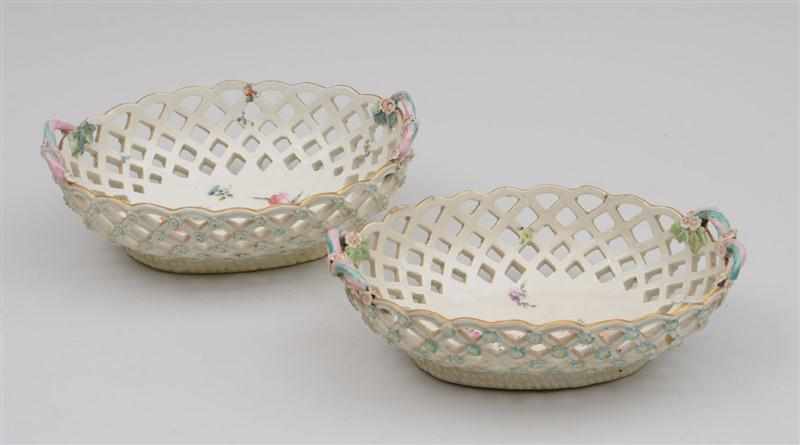 Appraisal: PAIR OF CHELSEA TYPE PORCELAIN FLORAL-ENCRUSTED RETICULATED BASKETS With pink