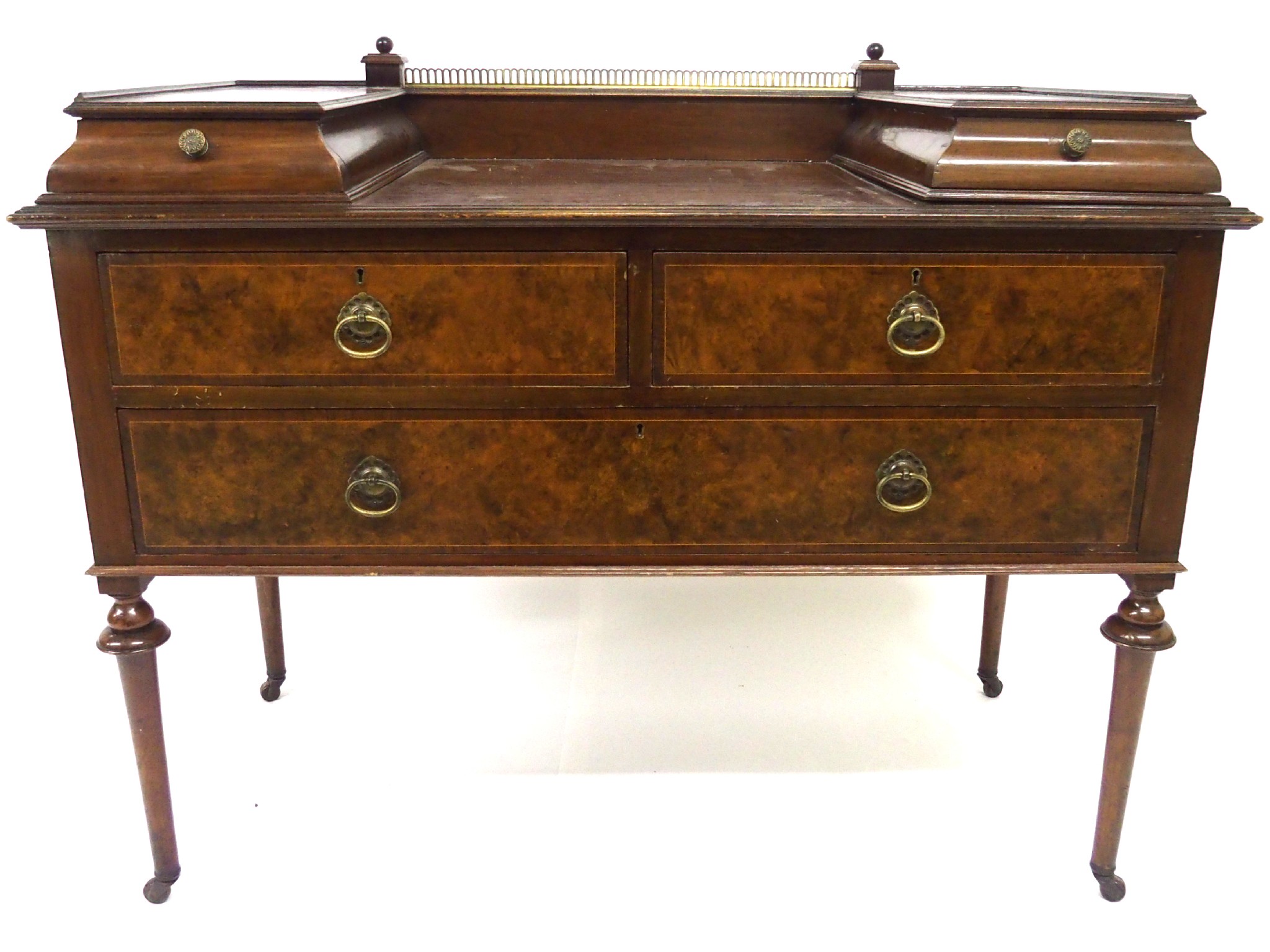 Appraisal: An Edwardian walnut dressing tablewith brass rail above a pair