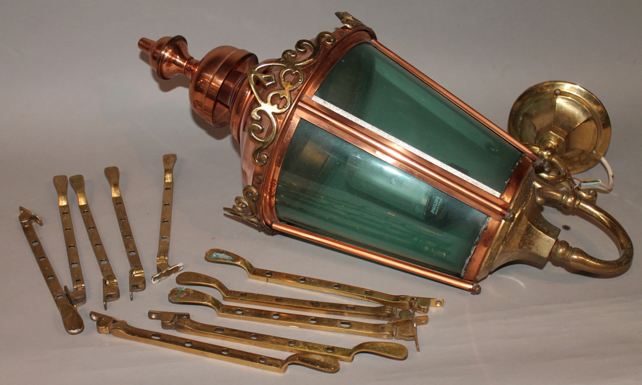 Appraisal: A thC copper and brass lantern with a scroll arm