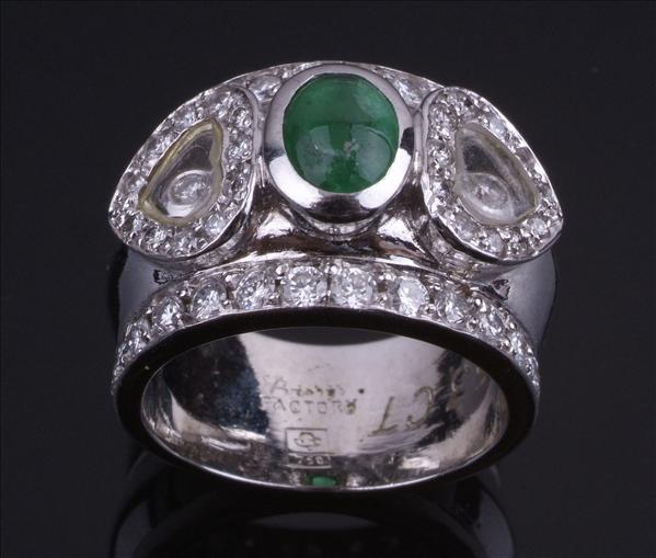 Appraisal: An emerald and diamond band ring by Fitahi the central