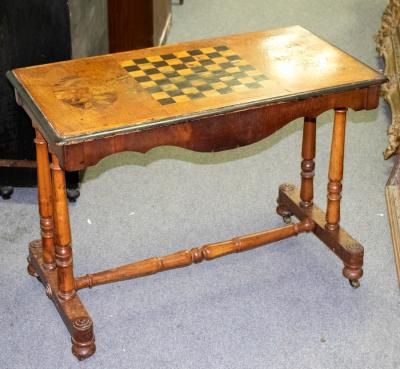 Appraisal: A Victorian walnut inlaid games table on twin turned columns