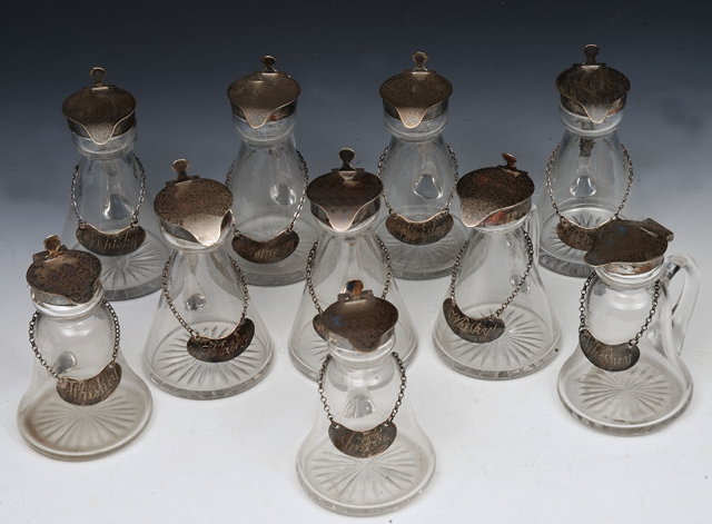 Appraisal: A COMPOSITE SET OF TEN NOGGIN TOT DECANTERS with silver