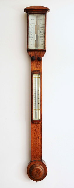 Appraisal: A VICTORIAN OAK STICK BAROMETER the twin ivory vernier scales