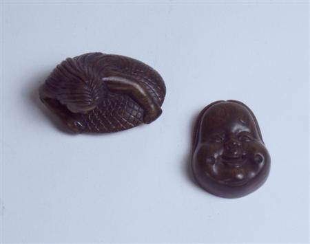 Appraisal: A Japanese rosewood netsuke Meiji period of a sleeping mermaid