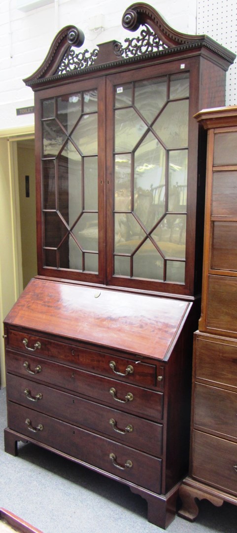 Appraisal: A George III mahogany bureau bookcase the pierced fret swan