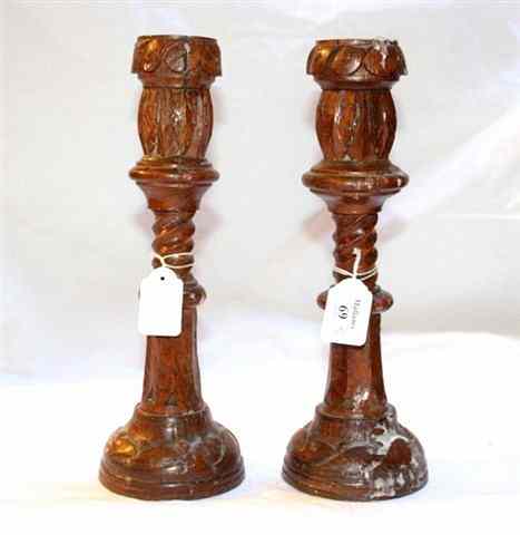 Appraisal: TWO CARVED OAK CANDLESTICKS inscribed on the base 'Made Out