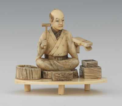 Appraisal: Carved Ivory Figurine of a Box Maker Seated on a